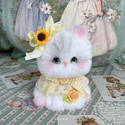 Fluffy kitten figurine from the Enchanted Big Paws Collection, dressed with a yellow ribbon and sunflower, showcasing kawaii style.