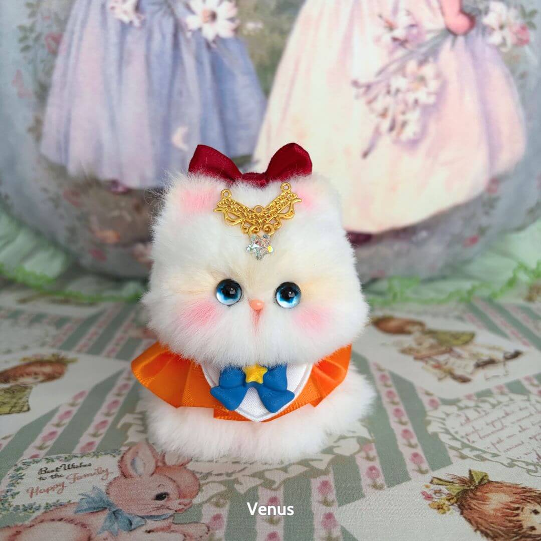 Moonbound Companions: handmade kitten figure in fluffy white fur, wearing a decorative bow and crown, styled with kawaii charm.