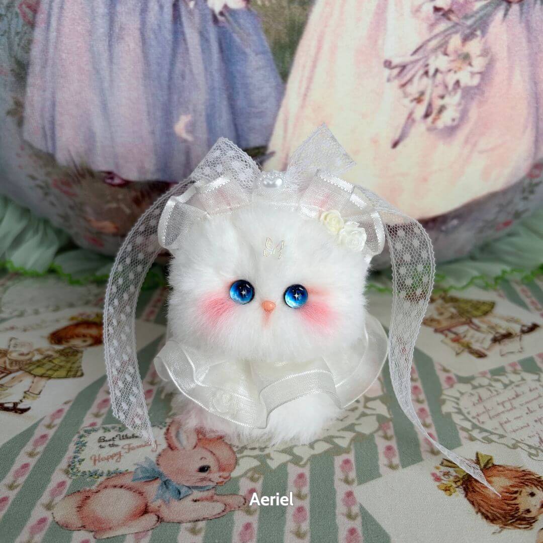 Adorable white handmade kitten from the Fairy Paws Collection, featuring blue eyes and satin ribbon accessories.