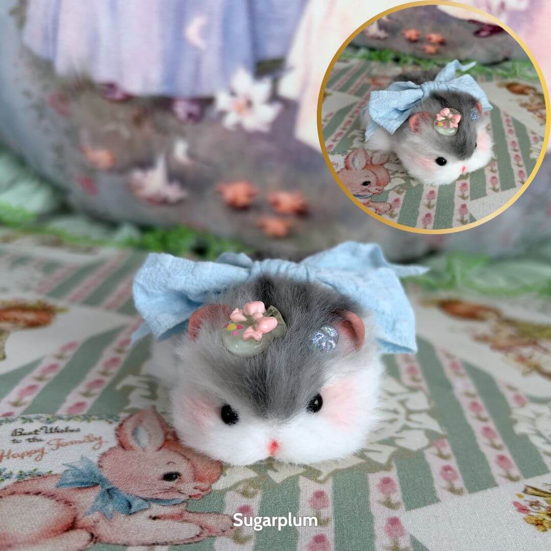 Cute Lying Hamsters Figurines with grey fur and blue bow, handmade collectible animal decor, resting on floral background.