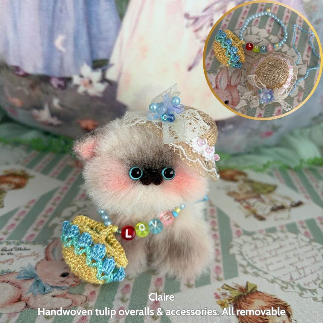 Spring Love Limited Collection fluffy kitten figurine wearing handmade tulip overalls, lace hat, and removable accessories.