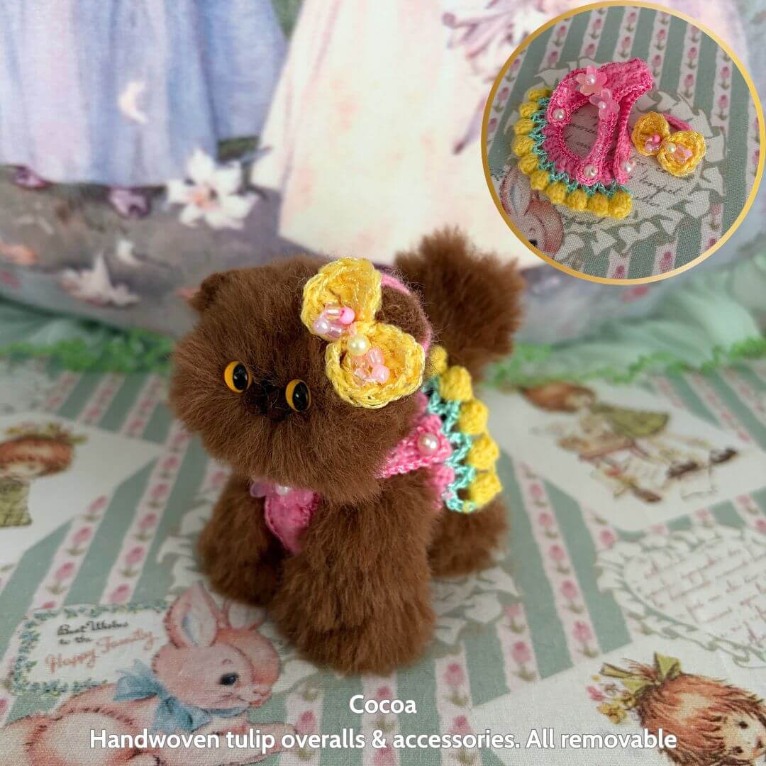 Spring Love Limited Collection handmade kitten in brown fluff, wearing cheerful handmade tulip overalls and accessories, cute kawaii style.