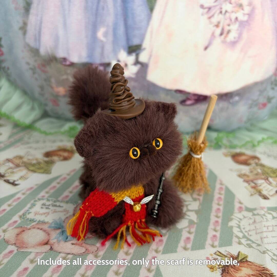 Handmade kitten figurine with a wizard hat and broom, flaunting a colorful scarf and fluffy fur, part of the Magic Kitty Companions.
