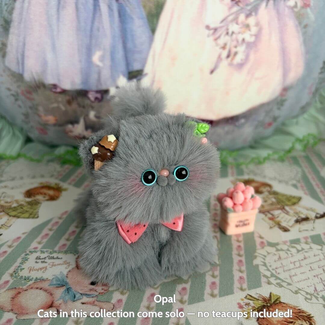 Fluffy Kitten Collection: adorable grey fluffy kitten with a pink bow and chocolate accessory, cute animal collectible, handmade in UK.