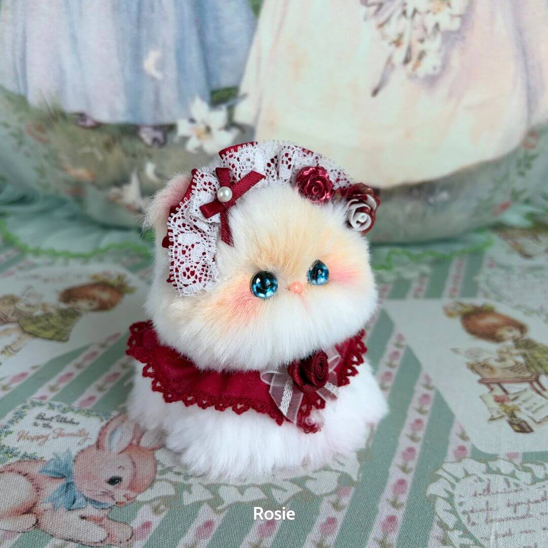 Handmade kitten from the Blossom Kitten Collection, fluffy and cute with a lace bow and floral accents, collectible cat figurine.