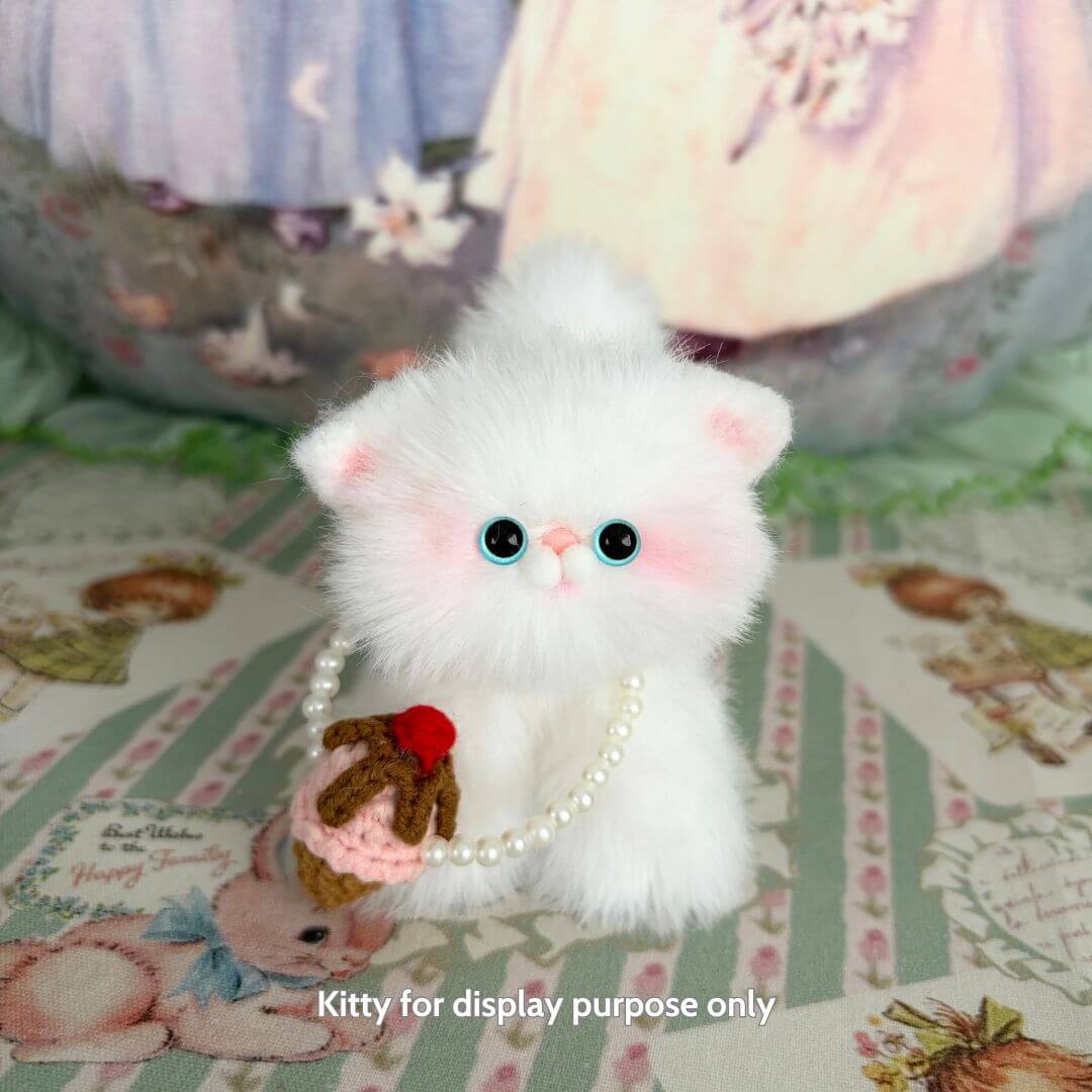 Adorable fluffy cat figurine with pearl necklace holding an ice cream cupcake, part of the Snuggle Bits collection.