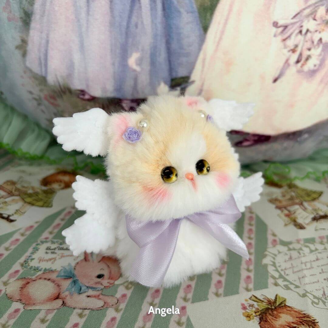 Handmade kitten from the Fairy Paws Collection with white wings, pastel colors, and a lavender bow, perfect kawaii cat figurine.