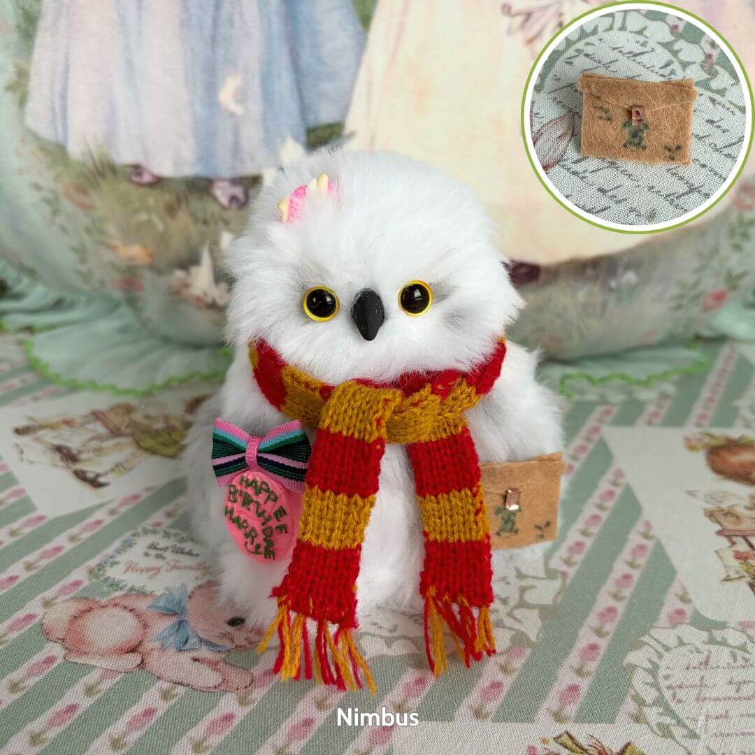 Fluffy Magic Owls miniature snowy owl with golden eyes, red and gold scarf, holding a mail satchel, cute collectible decor.