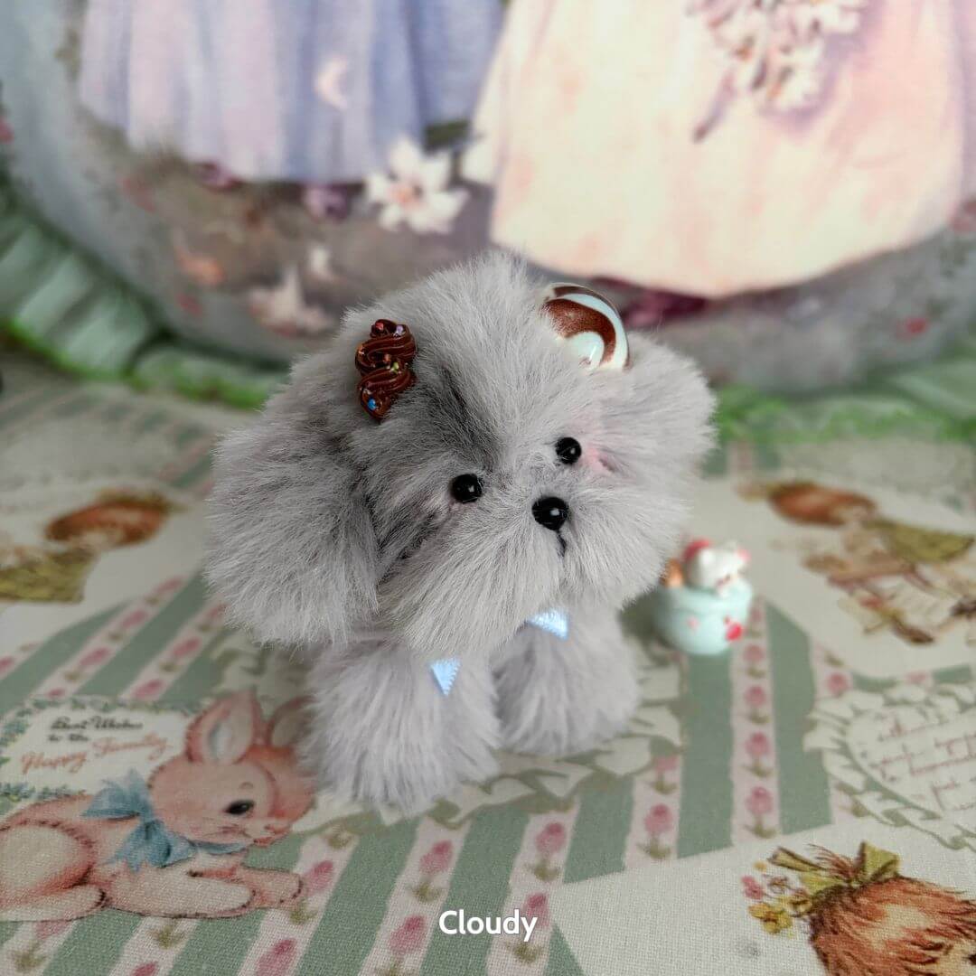 Adorable Puppy Collection featuring a fluffy grey puppy named Cloudy with a decorative hair accessory and cute pose.