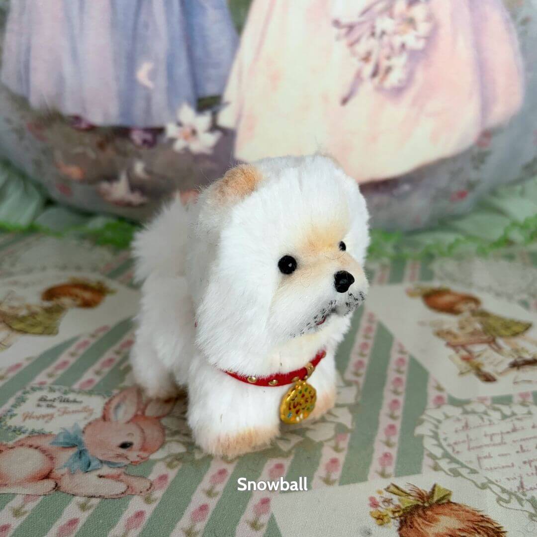 Lifelike Puppy Collection features a fluffy white dog figurine, detailed with a red collar and tag, perfect for collectors.