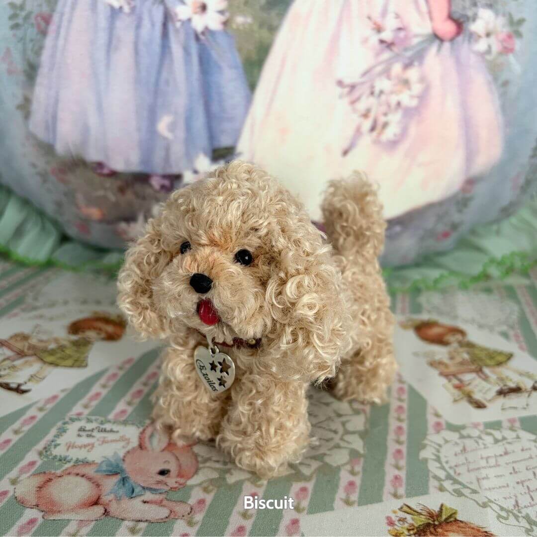 Lifelike Puppy Collection miniature beige poodle figurine with curly fur, charming expression, and heart pendant.