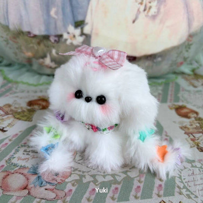 Handmade puppy from the Cosplay Puppy Collection, fluffy white fur with pastel-colored accents and a pink bow, posing adorably.