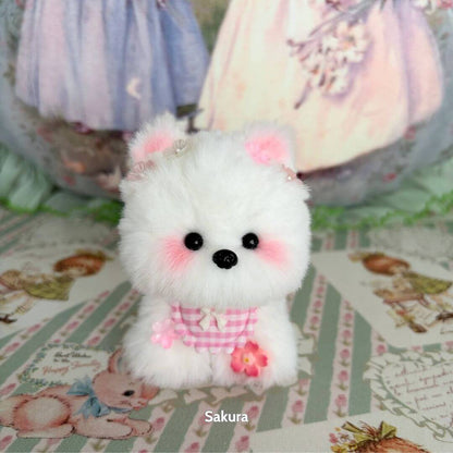 Adorable white puppy from the Cosplay Puppy Collection, featuring pink accents and a cute outfit with flower decoration.