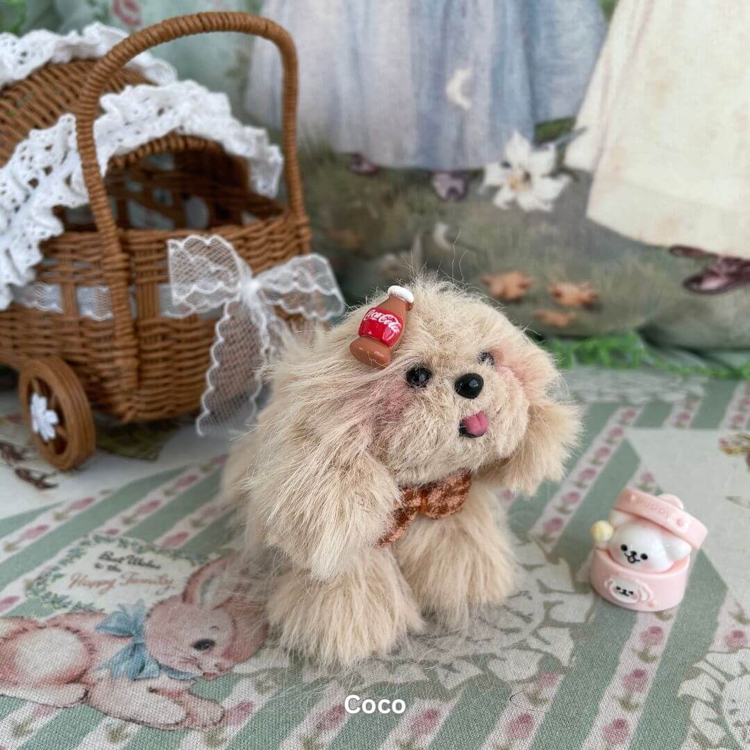 Handmade Fluffy Puppy plush toy with dessert-themed accessory, surrounded by cute decor, inspired by Pomeranians, ideal for display.