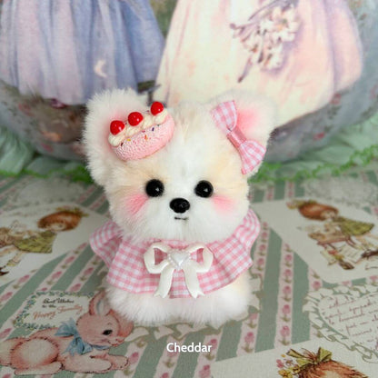 Adorable handmade plush puppy from the Cosplay Puppy Collection, wearing a pink gingham outfit and a dessert hat.