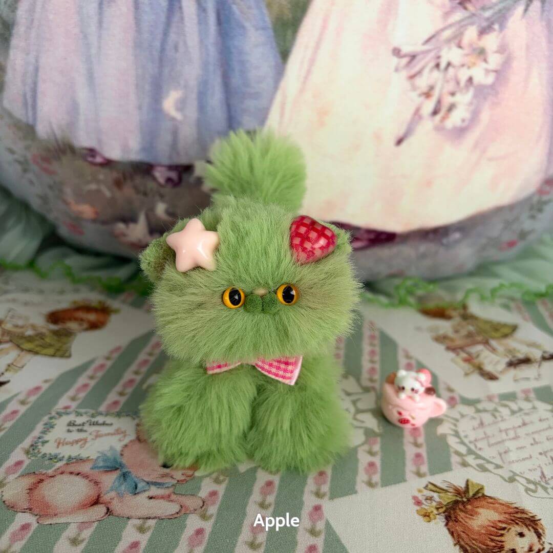 Handmade kitten from Fruity Kitten Collection, fluffy green cat figurine with strawberry and star accessories, kawaii style.