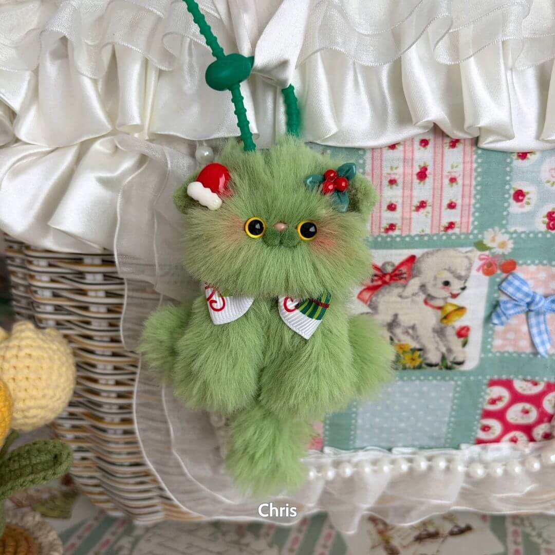 Adorable Kitten Pendants, fluffy green kitten figurine with a festive bow and decorations, cute handmade animal accessory.
