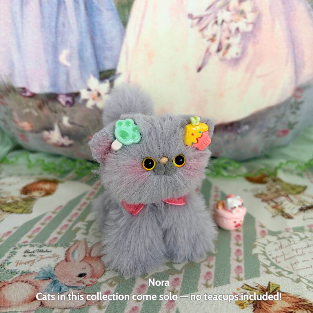 Handmade kitten in fluffy grey fur adorned with colorful accessories, part of the Grey Kitten Collection, cute animal collectible.