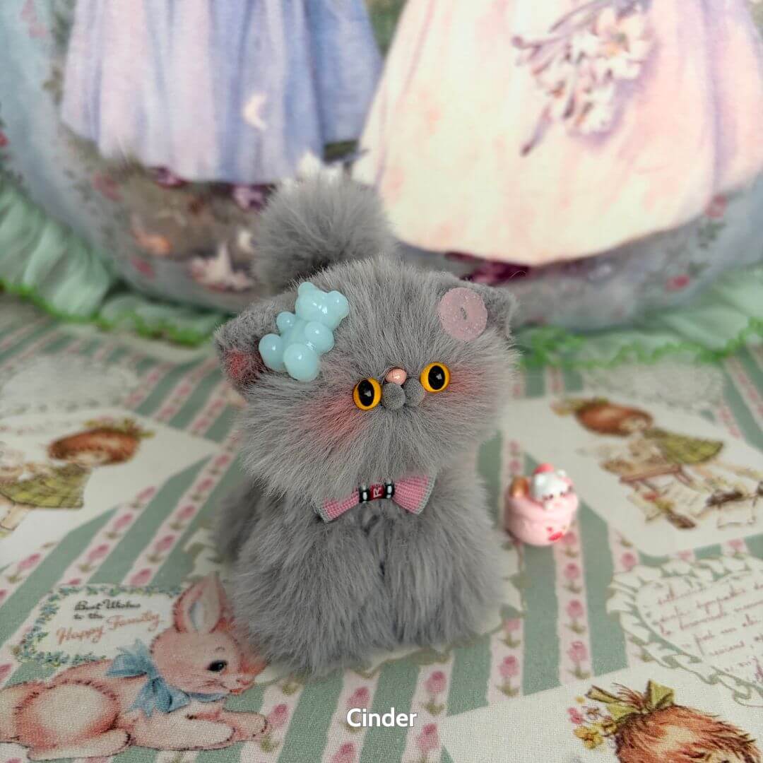 Handmade kitten from the Grey Kitten Collection, fluffy grey figurine with blue accessories, adorable pose, cute animal collectible.