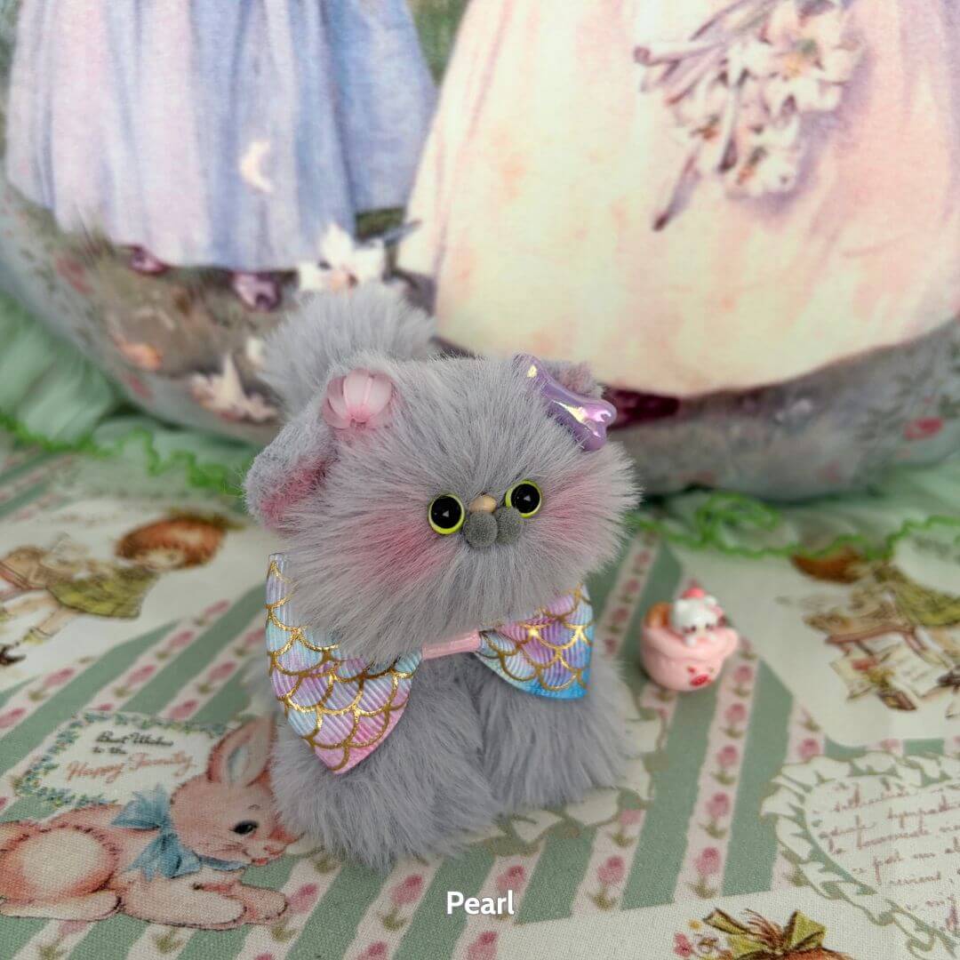Grey Kitten Collection: Handmade kitten Pearl in fluffy grey fur with a pastel bow, sitting beside a cute cupcake collectible.