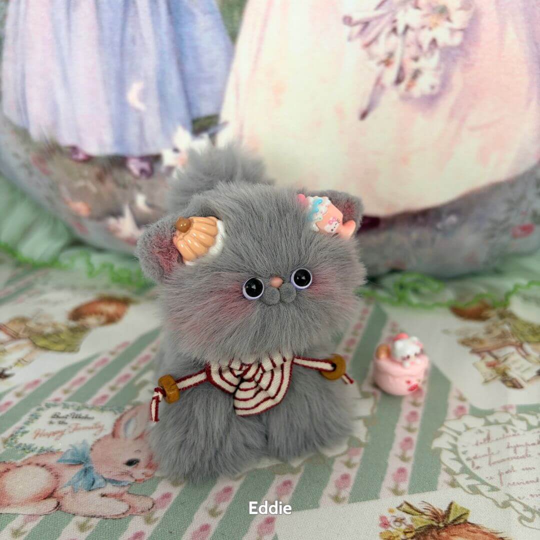 Adorable handmade kitten from the Grey Kitten Collection, featuring fluffy grey fur, candy hat, and cute pose.