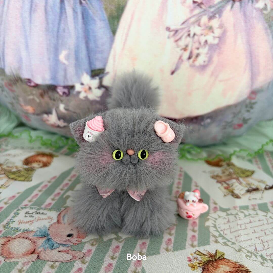 Alt Tag: Grey Kitten Collection featuring a fluffy grey kitten figurine with a pink cupcake accessory, handmade in the UK.