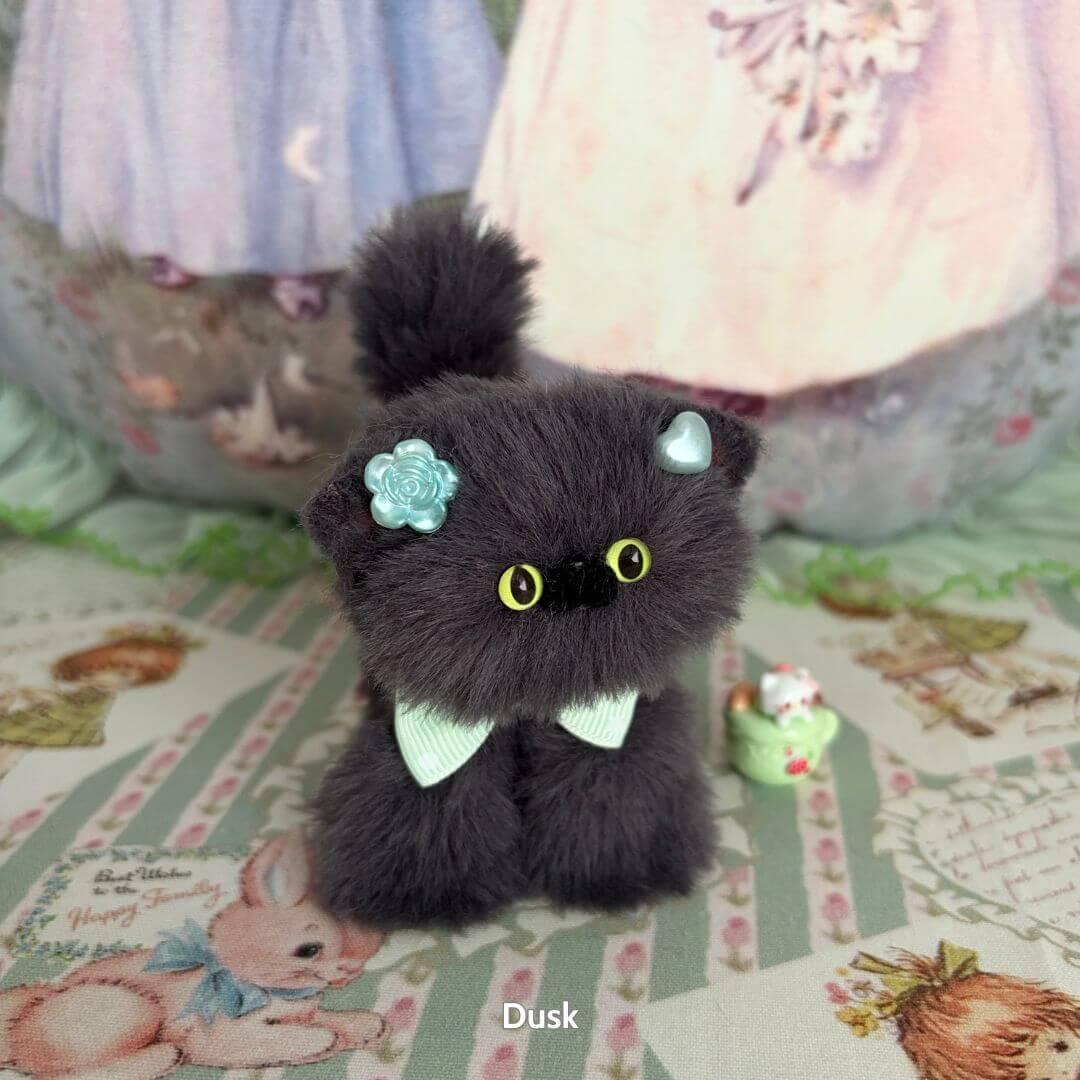 Alt Tag: Handmade kitten from the Grey Kitten Collection, fluffy black fur, adorned with mint bows, cute collectible decor.