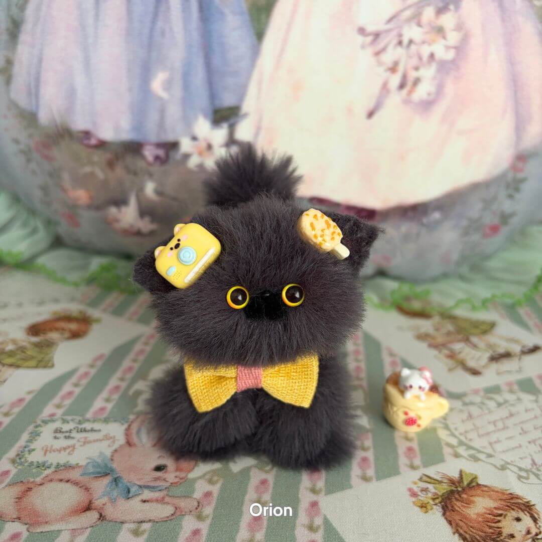 Handmade kitten from the Grey Kitten Collection, fluffy grey figurine with yellow bow and whimsical accessories.