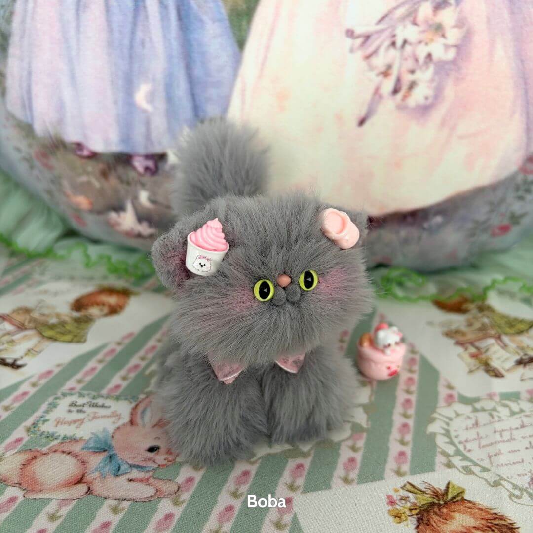 Cute grey kitten from the Grey Kitten Collection, wearing pink accessories and a cupcake, handmade in the UK.