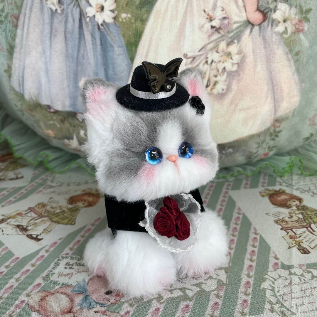 Fluffy gray and white kitten figurine dressed as a groom for the Enchanted Wedding of Mr. & Mrs. Paws, adorable kawaii style.