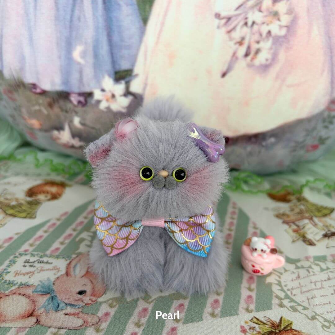 A cute, fluffy grey kitten figurine from the Grey Kitten Collection wearing a colorful bow tie, handmade in the UK, perfect for collectors.