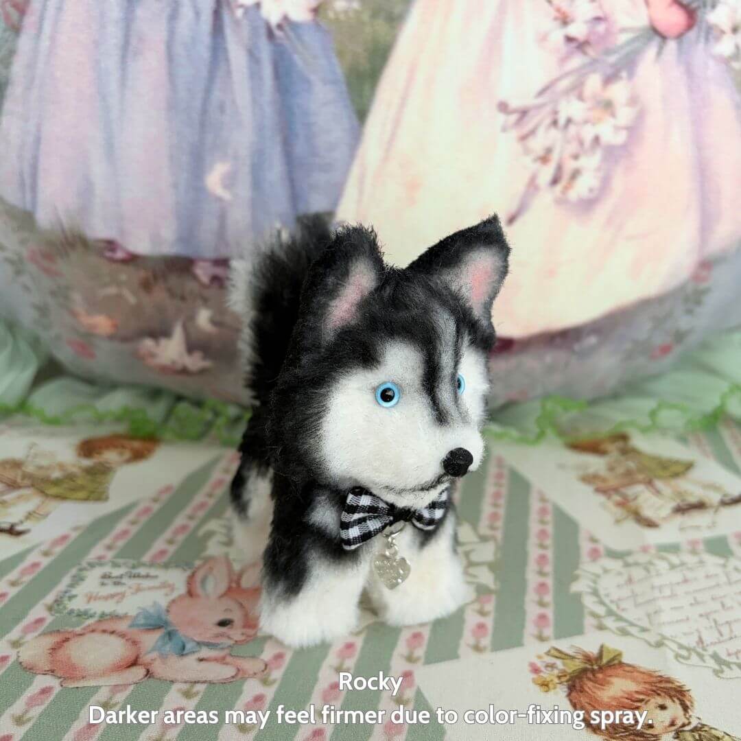 Lifelike Puppy Collection features a handcrafted black and white miniature husky dog figurine wearing a bowtie, exuding charm.