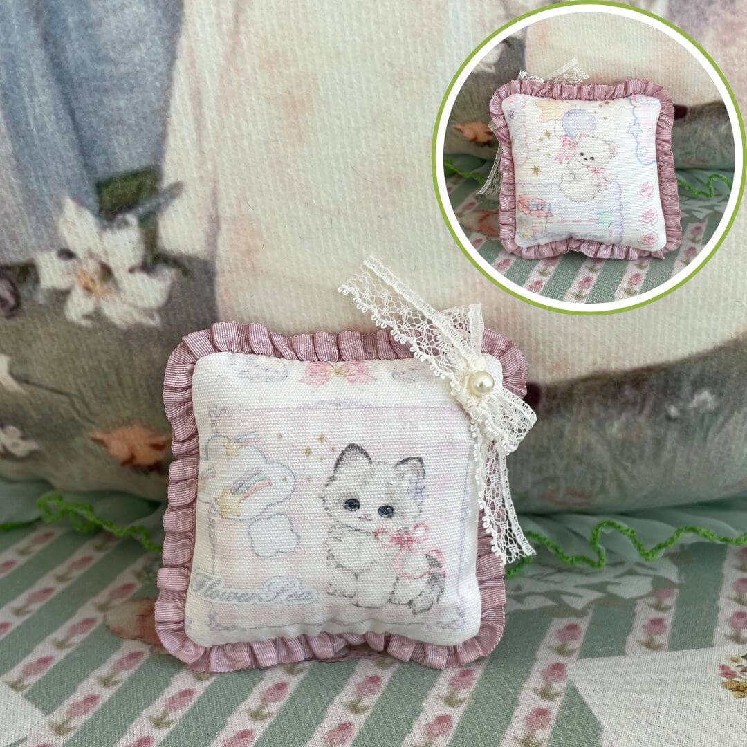 Handmade tiny cuddle critter cushion with kitten design, 6 cm, detailed with lace bow, perfect doll accessory or desk decor