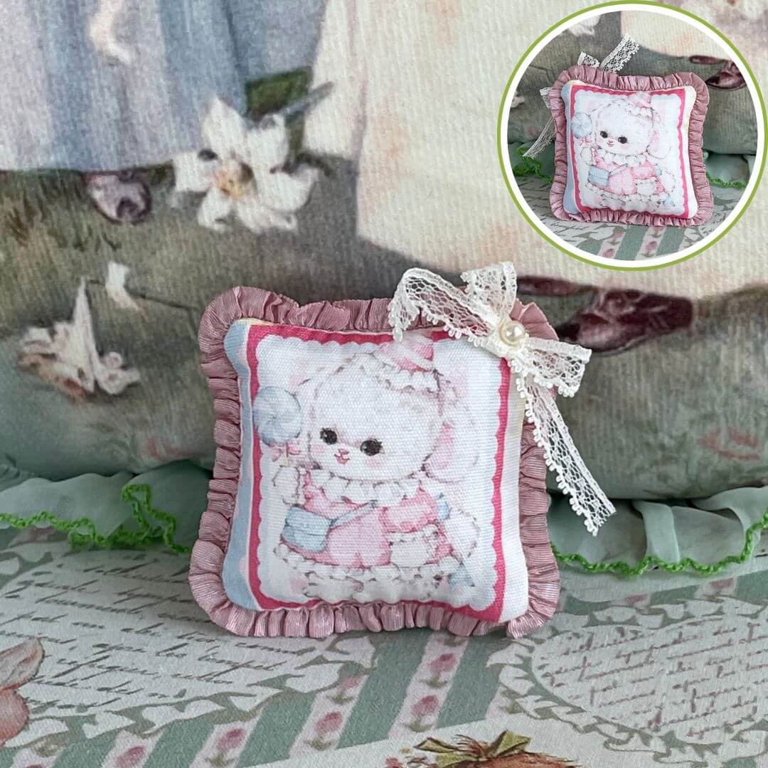 Handmade tiny cuddle critter cushion with kitten design, 6 cm, featuring delicate hand-stitched bow, perfect for dolls or desk decor.