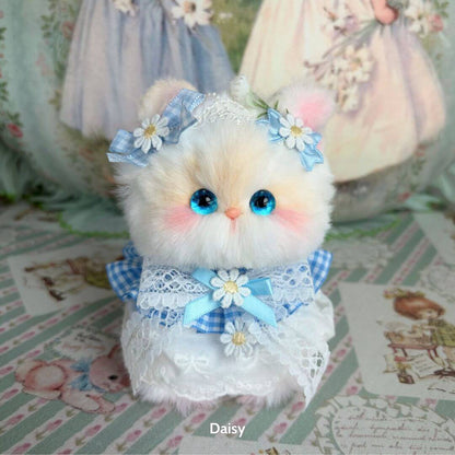 Adorable fluffy kitten figurine from the Enchanted Big Paws Collection, dressed in blue and lace, with cute blue eyes and accessories.
