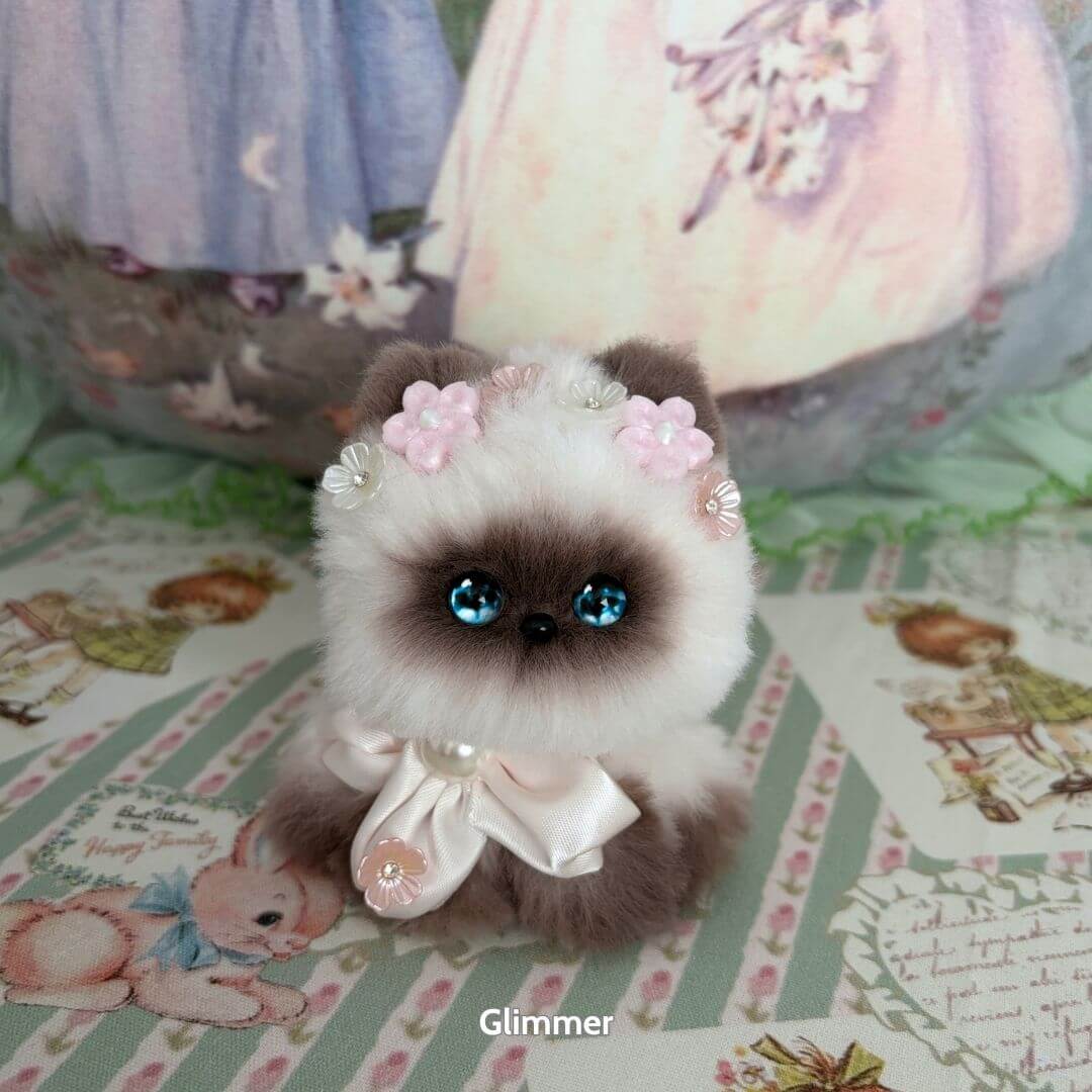 Alt Tag: Handmade kitten from the Fairy Paws Collection with blue eyes, floral crown, and silky ribbon, kawaii fluffy cat figurine.
