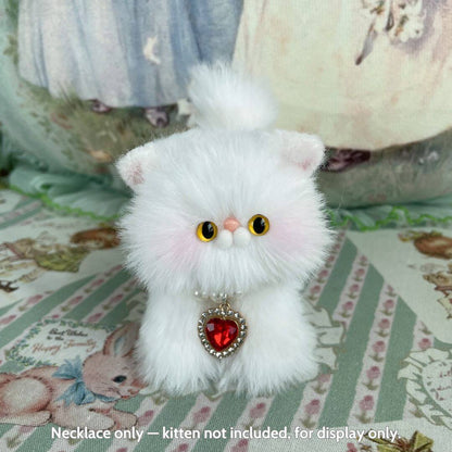 Elegant Heart Necklace on a fluffy white kitten figurine with bright eyes, perfect for collectible animal decor.