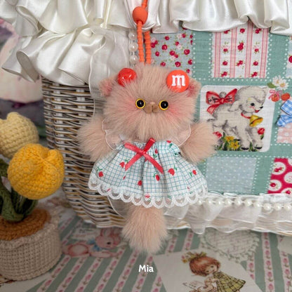 Pawsh Pendants handmade kitten in a cute plaid dress with red accents and fluffy fur, displayed as a collectible decoration.