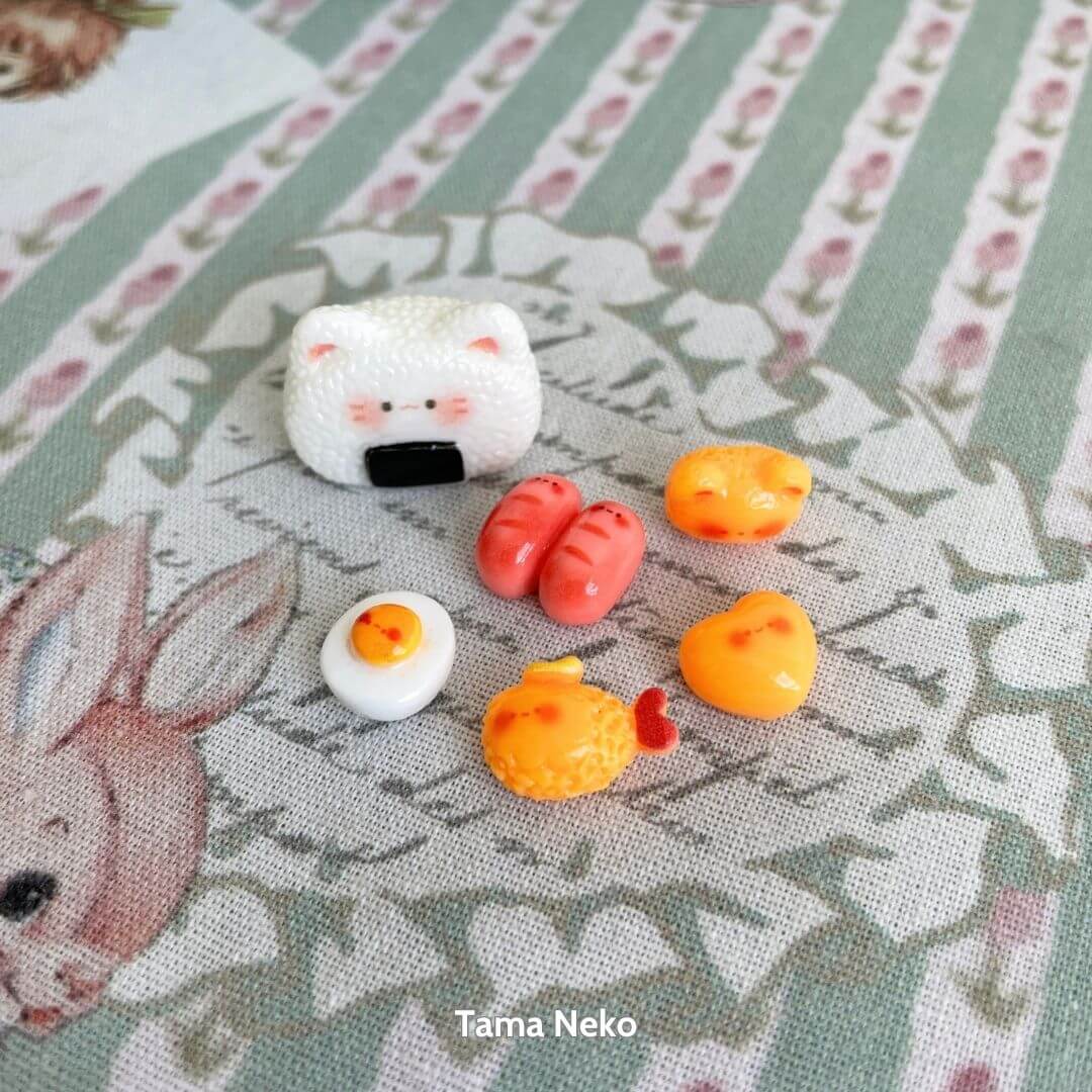 Mini Cat Bento Box featuring a handmade kitten, kawaii cat face, and colorful miniature food items like sushi and eggs.