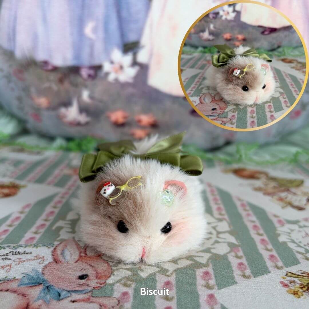 Lying Hamsters Figurines: cute beige hamster with green bow and candy-like accessories, laying flat on patterned fabric.