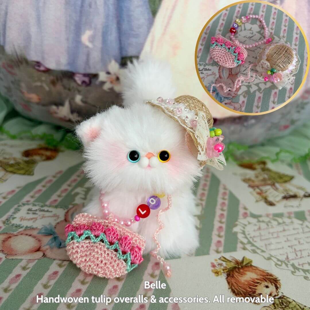 Spring Love Limited Collection plush kitten Belle in handwoven tulip overalls, fluffy white with cute accessories.