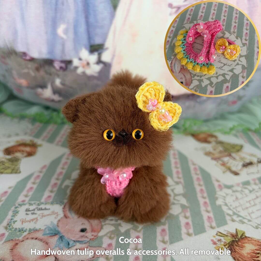 Spring Love Limited Collection handmade kitten dressed in pink tulip overalls, fluffy brown fur with yellow flower, cute animal collectible.