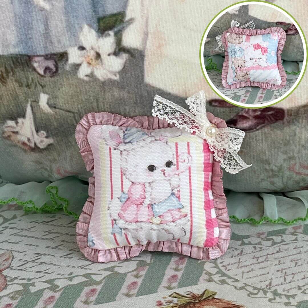 Handmade tiny cuddle critter cushion with kitten design, delicate hand-stitched bow, perfect for dolls or decor. Size: 6 cm x 6 cm.