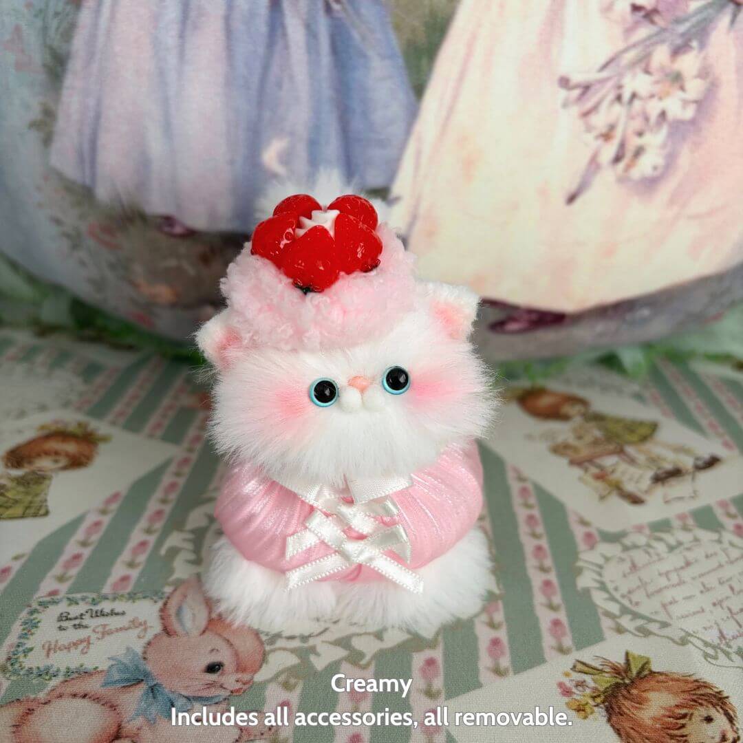 Sweet Treat Kitties handmade kitten with pink fur and dessert hat, featuring removable accessories, cute collectible decor.