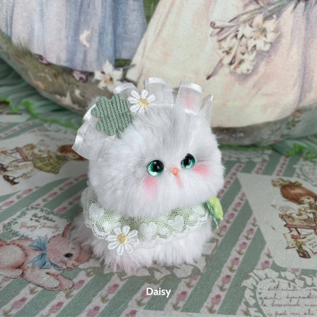 Handmade kitten from Blossom Kitten Collection, fluffy white with lace, bow, and floral accents, cute kawaii style.