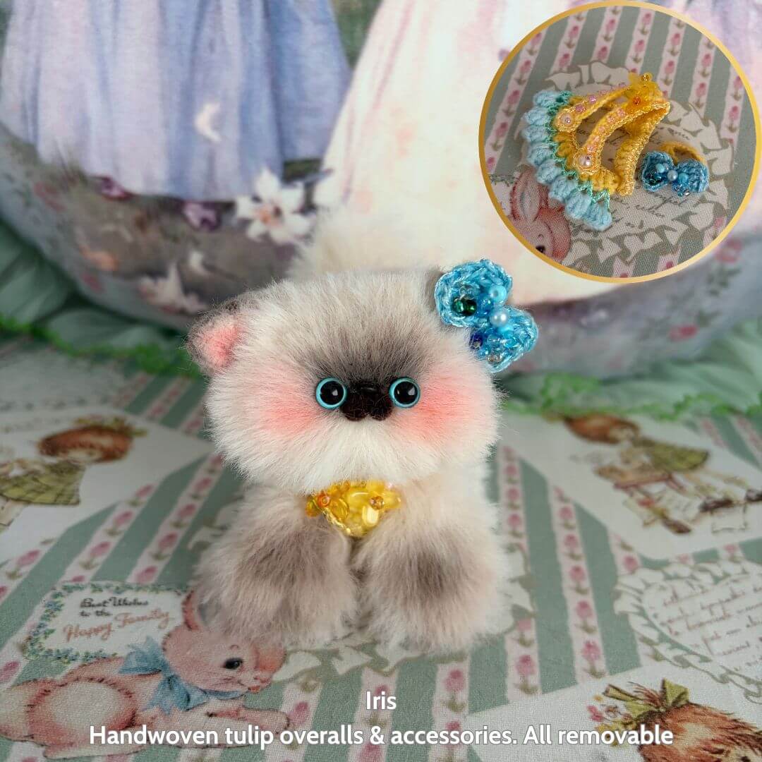 Spring Love Limited Collection handmade kitten with fluffy fur, blue accessories, and a cute pose, sitting on patterned decor.