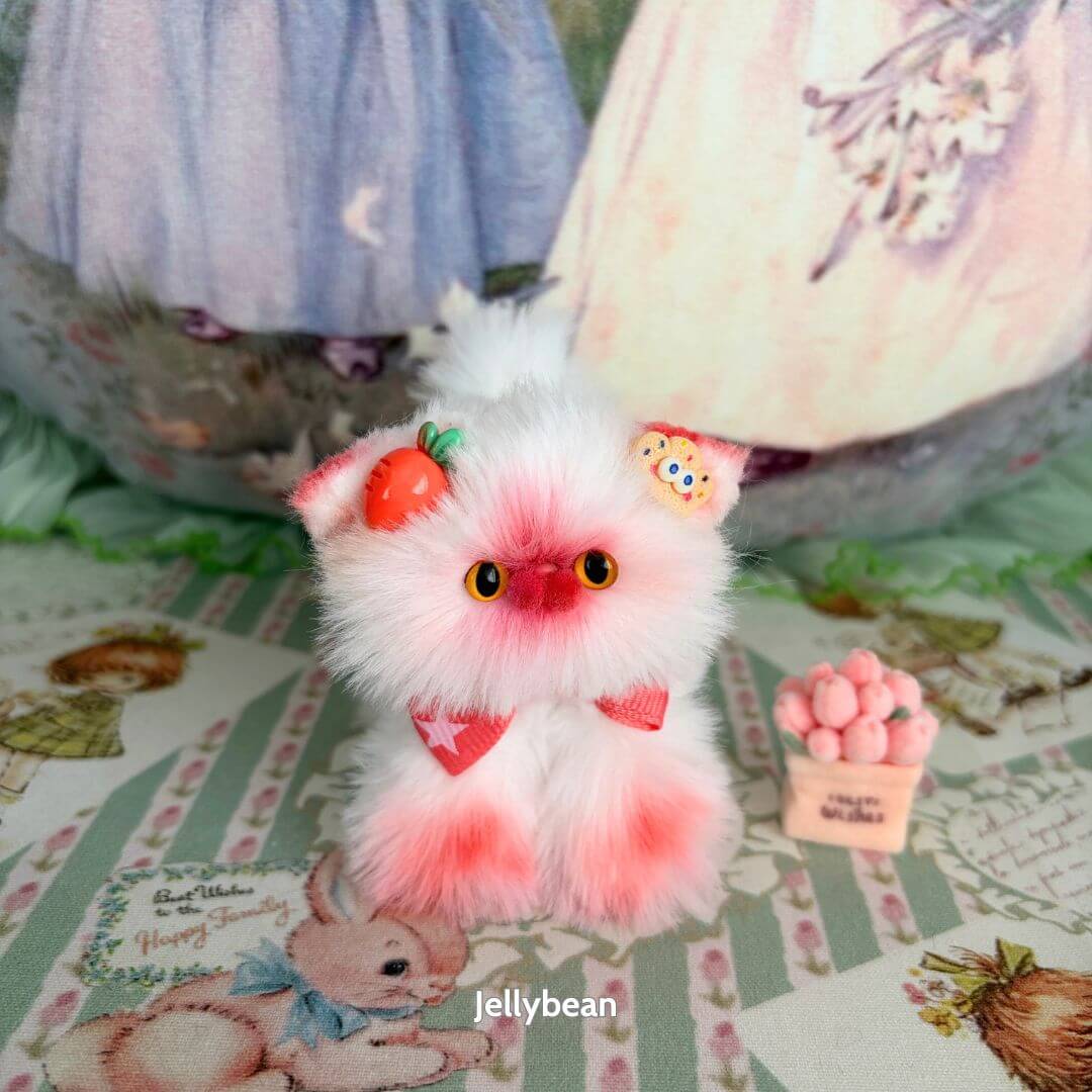 Handmade kitten from the Sweet Dreams Kitten Collection, featuring pink and white fluffy fur, cute accessories, and adorable expressions.