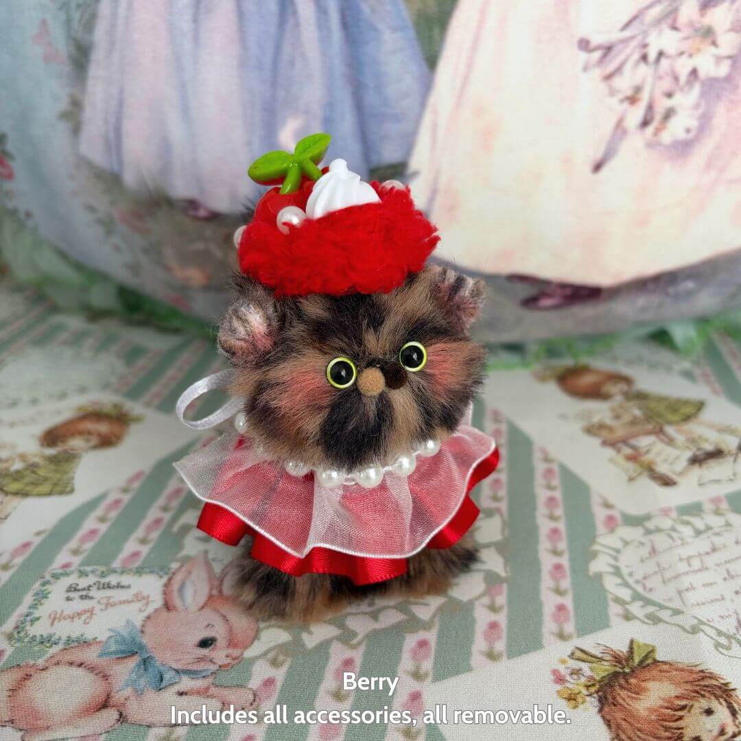 Sweet Treat Kitties handmade kitten wearing a strawberry hat and pink dress with removable accessories, cute collectible cat figurine.