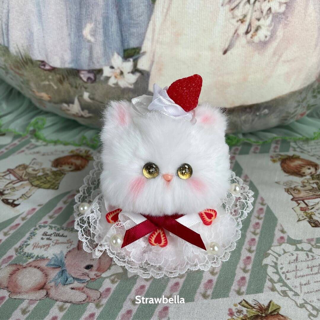 Mewlicious Collection: adorable fluffy kitten figurine with strawberry hat, soft white fur, wearing lace with strawberry accents, handmade in UK.