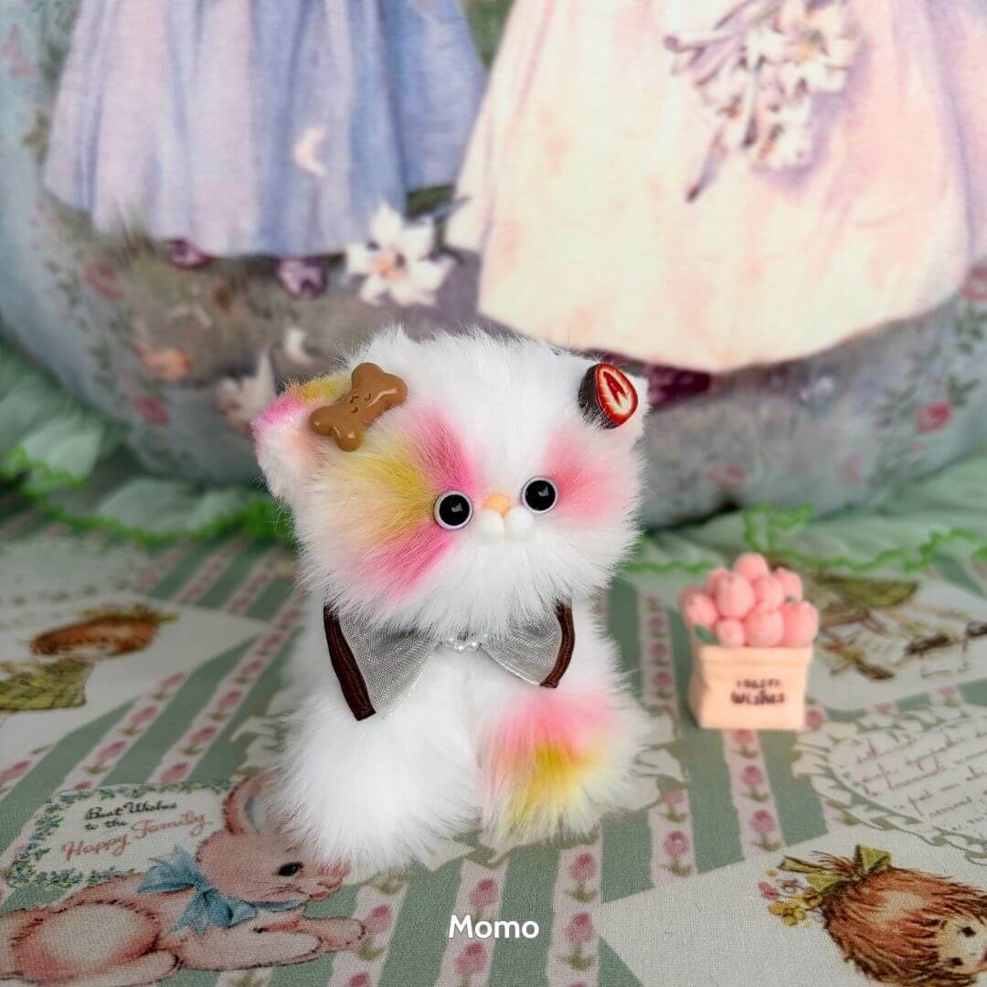Sweet Dreams Kitten Collection handmade kitten figurine in pastel colors, wearing a bow and charm, cute kawaii style.